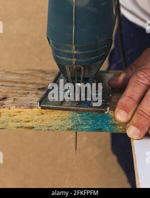 Sawing wood by hand worker Stock Photo