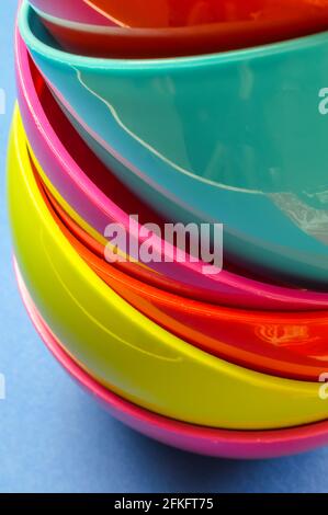 narrow view of a colorful stack of plastic bowls - abstract colorful background Stock Photo