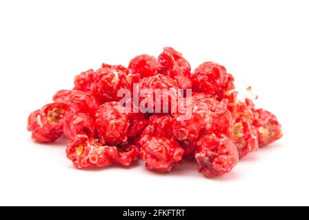 Red Colored Candy Coated Popcorn on a White Background Stock Photo