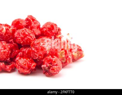 Red Colored Candy Coated Popcorn on a White Background Stock Photo