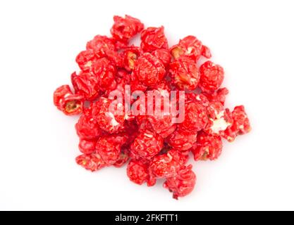 Red Colored Candy Coated Popcorn on a White Background Stock Photo