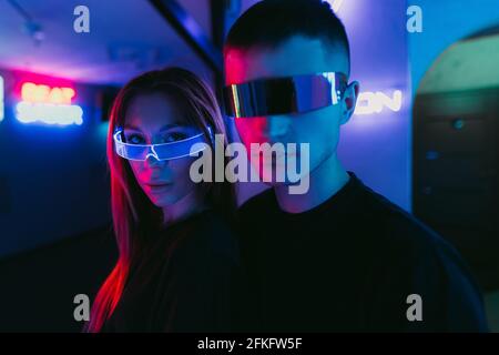 Man and woman in futuristic style. Neon noir Stock Photo