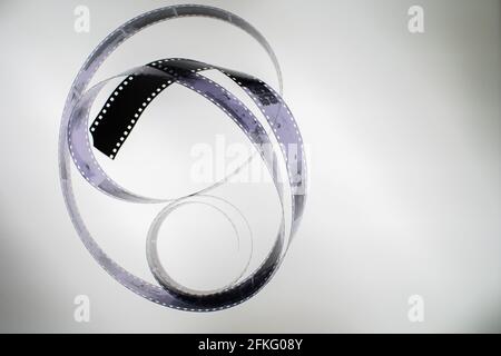 Analog black and white 35mm negative film strip on light table, top view with copy space Stock Photo