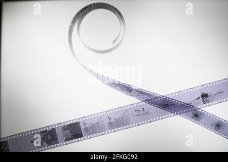 Analog black and white 35mm negative film strip on light table, top view Stock Photo