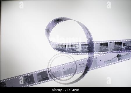 Analog black and white 35mm negative film strip on light table, top view Stock Photo