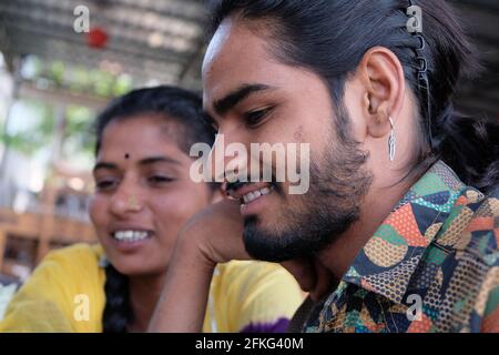 Smiling young Indian friends having fun in a cafe Stock Photo