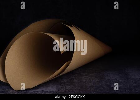 A paper cone on a dirty light and dark blue background Stock Photo
