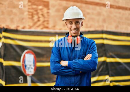 Young caucasian worker smiling happy wearing uniform at the city. Stock Photo