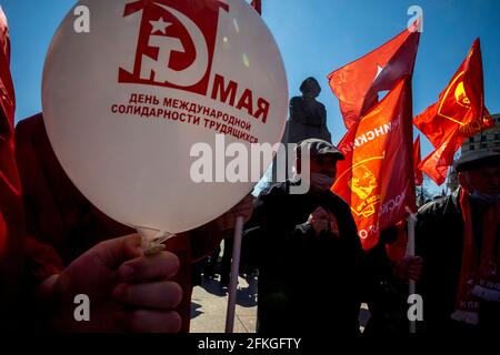 Moscow, Russia. 1st of May, 2021 Сommunists party supporters gather with balloons and red flags to mark Labour Day, also knows as May Day near Red Square in Moscow, Russia, The inscription on the ball reads 'The May 1st. The International Workers' Solidarity Day' Stock Photo