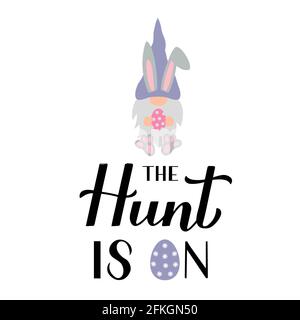 The hunt is on calligraphy hand lettering with cute gnome bunny holding egg. Funny Easter quote typography poster. Vector template for party invitatio Stock Vector