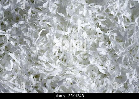 Shredded paper texture background, top view of many white paper strips. Pile of cut paper like confetti for party or box filler for shipping fragile i Stock Photo