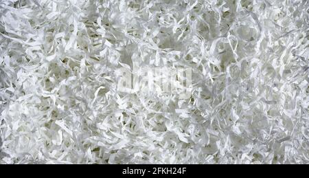 Shredded paper texture background, top view of many white paper strips. Pile of cut paper like confetti for party or box filler for shipping fragile i Stock Photo