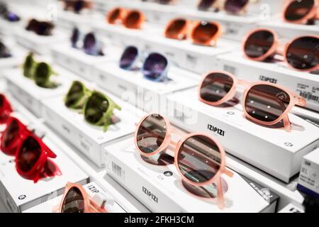 Sunglasses stand on the shop shelf. Sun glasses in Rinascente, collection of high-end stores with Italian and international brands. Milan, Italy -