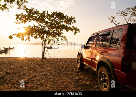 24 January 2021 Red 4x4 car Suzuki Vitara 1993 on the rawai beach Tropical sea view Beautiful nature sea view at sunrise in Phuket Thailand. Stock Photo