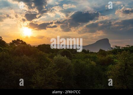 Sunset landscape in the savannah with Hanglip or Hanging Lip mountain peak, Entabeni Safari Game Reserve, Waterberg, Limpopo Province, South Africa. Stock Photo