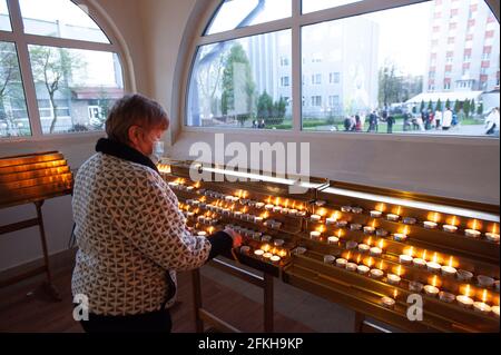 Lviv, Ukraine. 01st May, 2021. An old woman lights up candles at a Church as they celebrate Easter to mark the resurrection of Jesus Christ from the dead and the foundation of the Christian faith. Credit: SOPA Images Limited/Alamy Live News Stock Photo