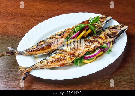 Mackerel cooked on the grill is on a white plate Stock Photo