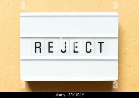 Lightbox with word reject on wood background Stock Photo