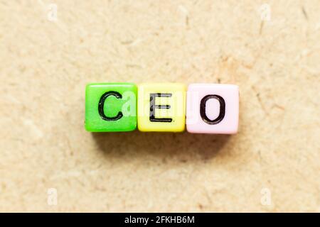 Color alphabet letter block in word CEO (Abbreviation of Chief Executive Officer) on wood background Stock Photo