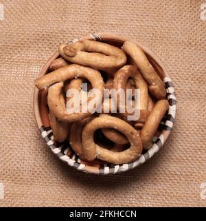 Salty pretzels isolated on brown background. Directly above. Stock Photo