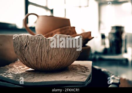 Ceramic utensils in art studio. Traditional pottery craft. Ceramics workshop concept Stock Photo
