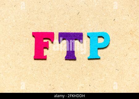 Color cloth alphabet letter in word FTP (Abbreviation of File Transfer Protocol) on wood background Stock Photo