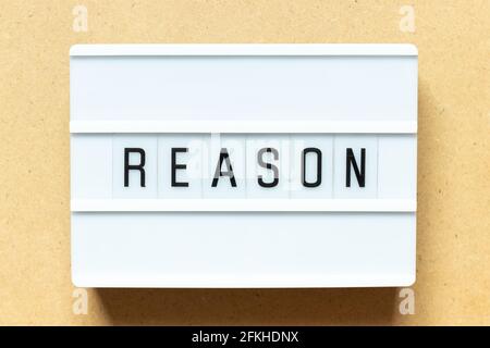 Lightbox with word reason on wood background Stock Photo