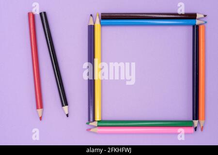 Frame of colored pencils for drawing on a lilac background. Stock Photo