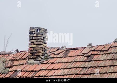 old chimney from the brick of a dilapidated house Stock Photo