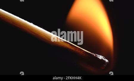 Photo of burning wooden matchstick on black Stock Photo