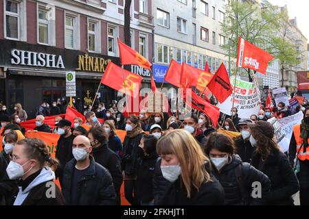 Berlin, Germany - May 01, 2021: Protesters holding a banners and flags at 1st May Demonstrations in Berlin Stock Photo