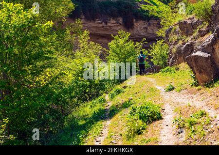 Hiker on a trail in a mountain canyon Stock Photo