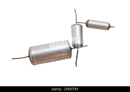 retro electronic components of high quality. set of three vintage metal-paper capacitors of different rate, with green ends, items of various capaciti Stock Photo
