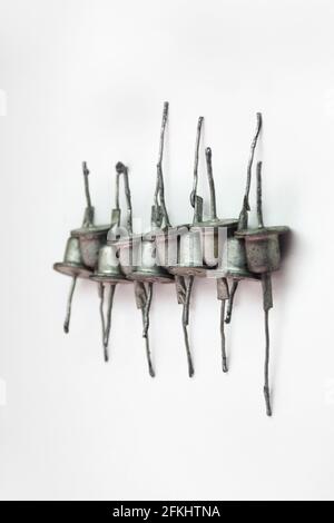 row of rectifier diodes. Old electronic components, look like hats Stock Photo