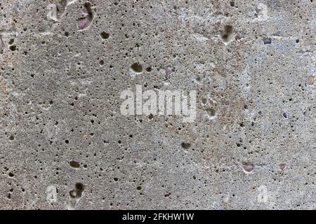 A flat grey concrete textured surface covered in air bubbles Stock Photo