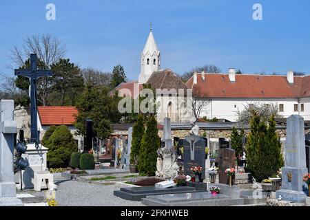 Margarethen am Moos, Austria - April 24, 2021: The old parish church is surrounded by a Romanesque charnel house from 1233, was a former monastery - n Stock Photo
