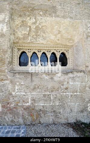Austria, window of the Romanesque charnel house from 1233, part of the parish church of Margarethen am Moos Stock Photo