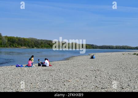 Haslau, Austria - April 24, 2021: Unidentified people have a picnic on the gravel bank on shore of Danube river in Donau-Auen National Park in Lower A Stock Photo