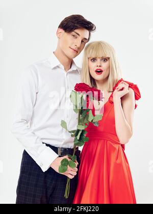 a man gave his beloved a bouquet of red flowers on a light background Stock Photo