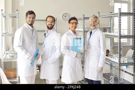 Diverse scientist group in medical science laboratory looking at camera Stock Photo