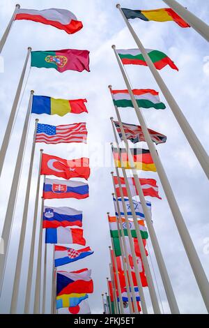 Flags of different countries on flagpoles Stock Photo