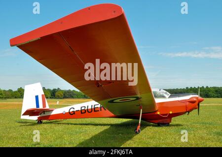 Slingsby T.61F Venture motor glider G-BUEK on the grass strip at Henham Park, Suffolk, UK. Formerly XZ559 with Royal Air Force air cadet training Stock Photo