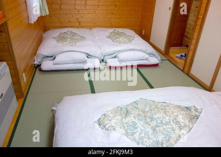 Japanese traditional bed on tatami mats Stock Photo