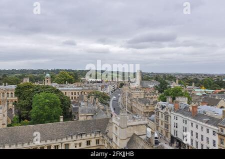 Rooftop view on historical university buildings towards Queens College and Magdalen Tower, Oxford, United Kingdom. Overcast sky. Stock Photo