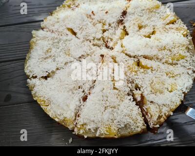 Homemade round sponge cake or chiffon cake on white plate so soft and delicious with ingredients: eggs, flour, milk on wood table. Homemade bakery con Stock Photo