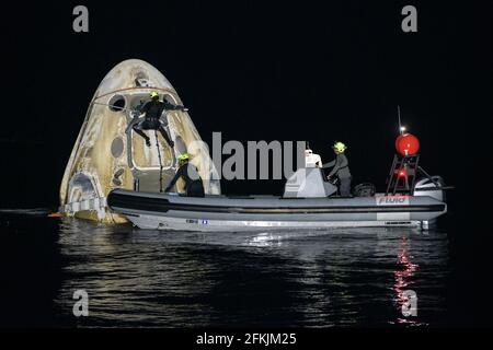 Gulf of Mexico. 2nd May, 2021. Support teams work around the SpaceX Crew Dragon Resilience spacecraft shortly after it landed with NASA astronauts Mike Hopkins, Shannon Walker, and Victor Glover, and Japan Aerospace Exploration Agency (JAXA) astronaut Soichi Noguchi aboard in the Gulf of Mexico off the coast of Panama City, Florida, on Sunday, May 2, 2021. Credit: UPI/Alamy Live News Stock Photo