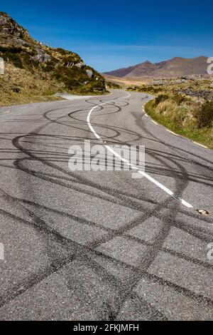 Black tire burnout track on rural road due to illigal car drifting Stock Photo