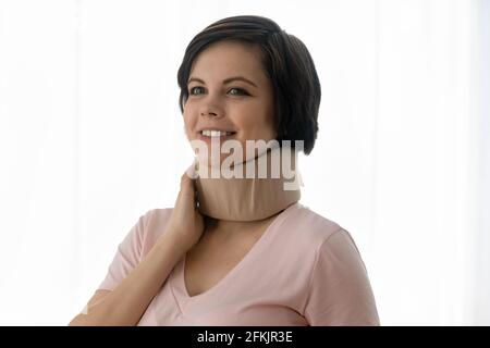Smiling young pregnant woman in cervical neck collar Stock Photo