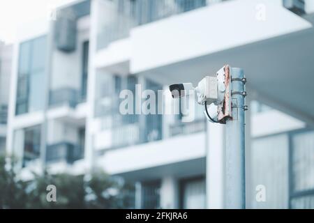 CCTV. video surveillance camera is mounted on a pole outside an apartment building for monitor security. Stock Photo