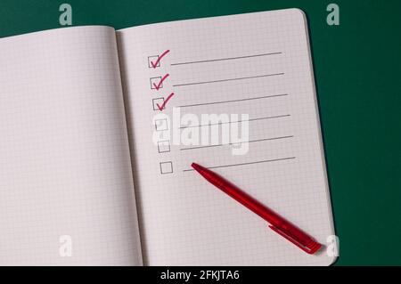 To-do list with several points. Open notebook on green background. . Large text field Stock Photo